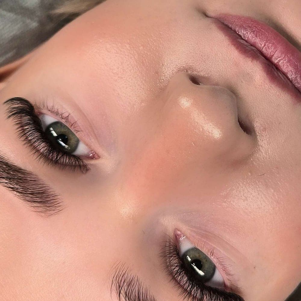 Lifted lashes and a softly shaped brow, close up