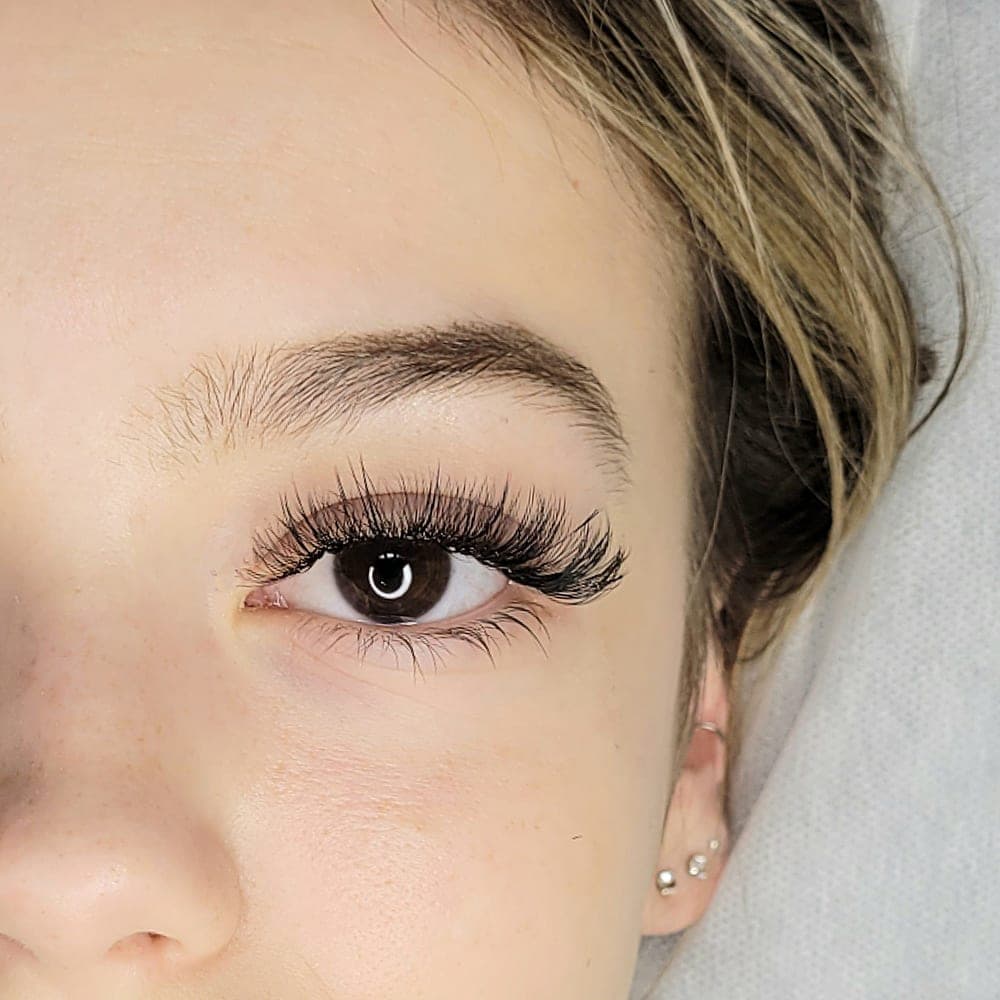A close-up of finished lashes and a defined brow