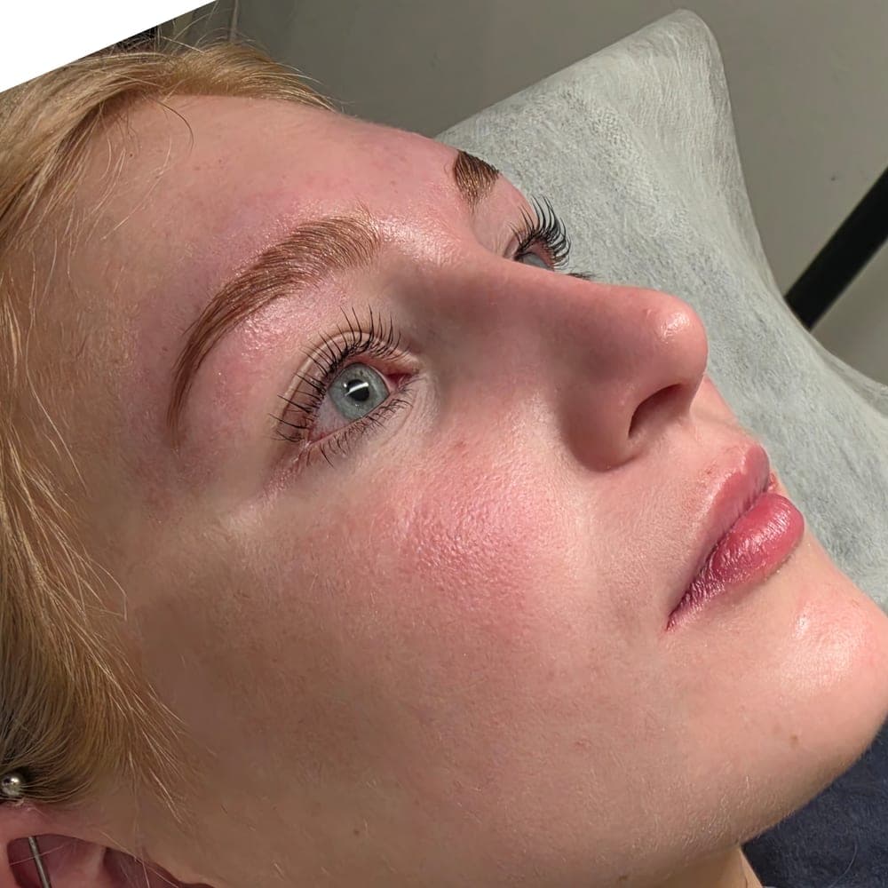 A client resting in the studio chair after her lash treatment