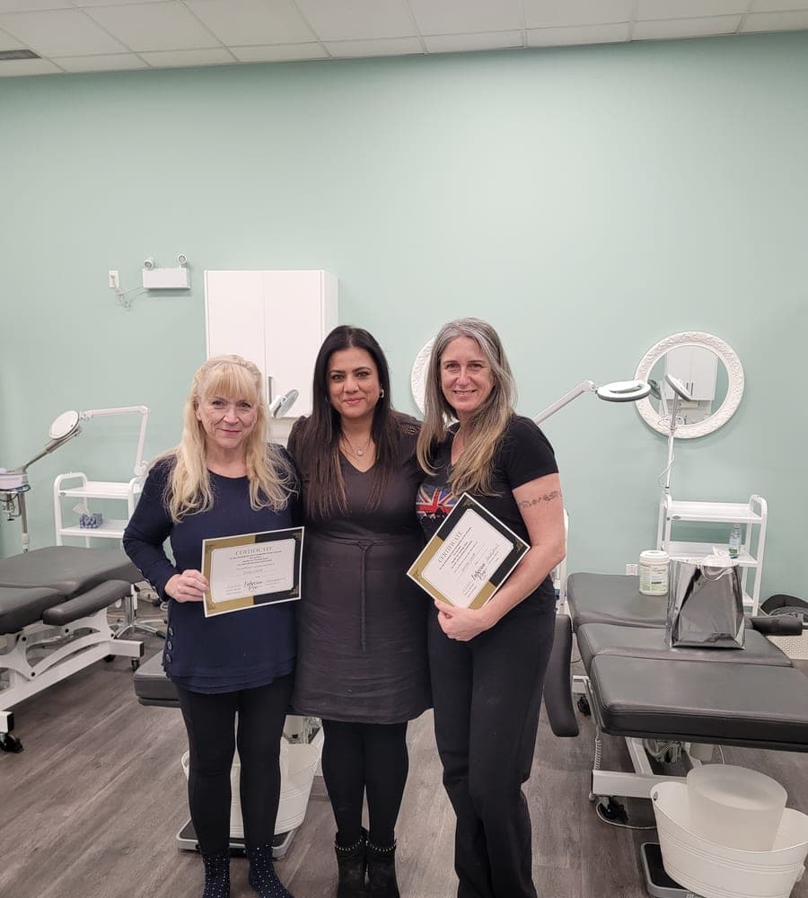 Graduates celebrating their certification in the studio